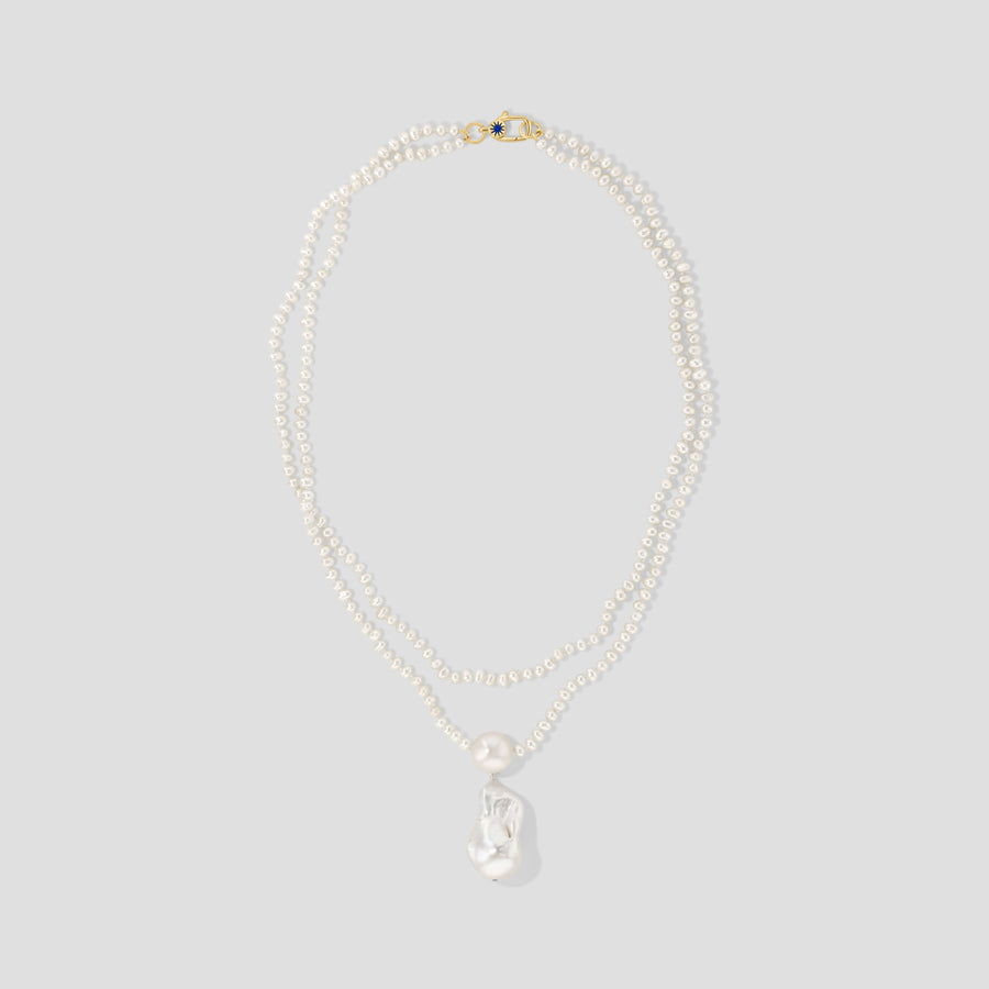 The Double Strand Necklace in 14k yellow gold: two strands of small white freshwater pearls meeting at a baroque pearl drop