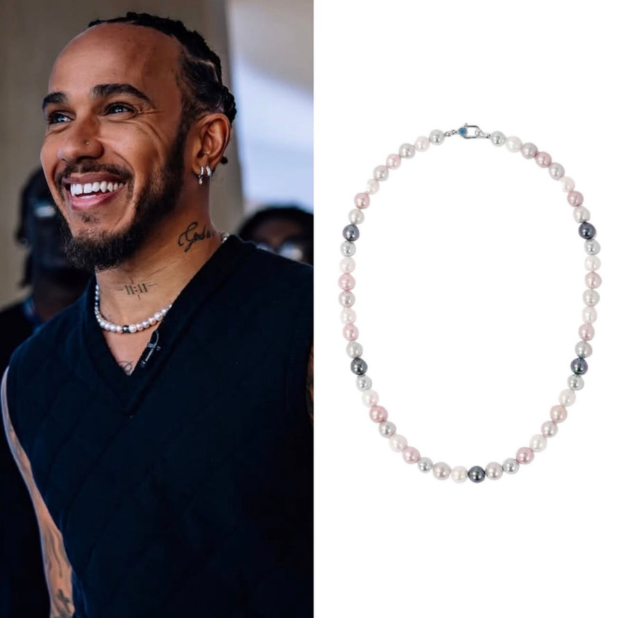 Lewis Hamilton smiling in a black sleeveless top, a pearl necklace at his collar, beside the Dreamy Multicolor Necklace laid flat
