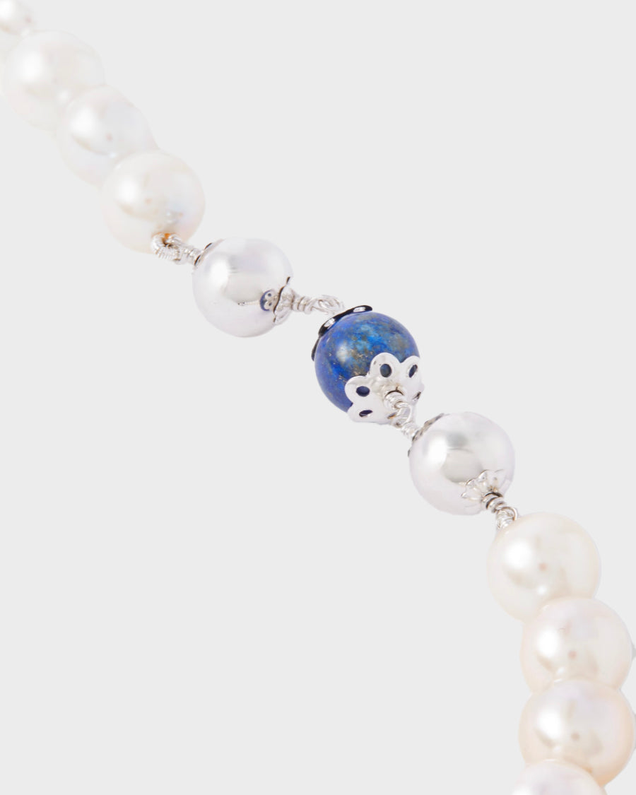 A natural lapis bead between two 14k white gold beads on the H20 Pearl Necklace