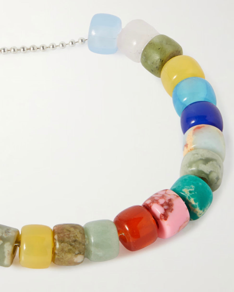 The Protection Bracelet up close: natural gemstone beads in blue, green, yellow, coral and pink on a sterling silver ball chain